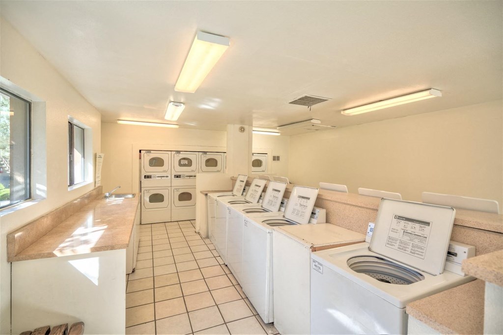 A laundromat with rows of washers and dryers.
