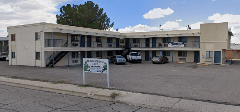 A motel with a sign that says "Parking Available".