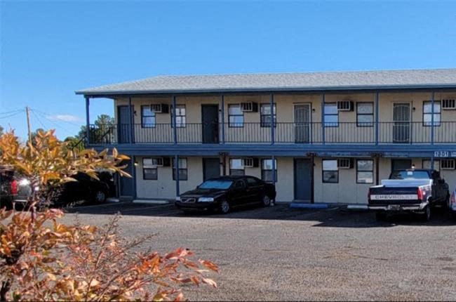 A building with a car parked in front of it.