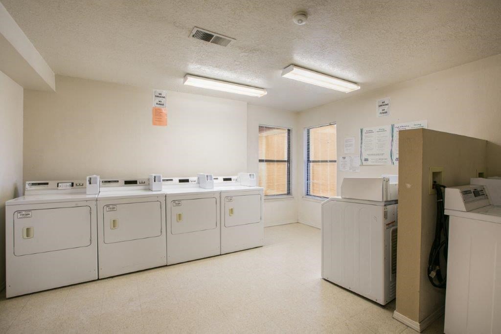 A laundry room with washers and dryers.