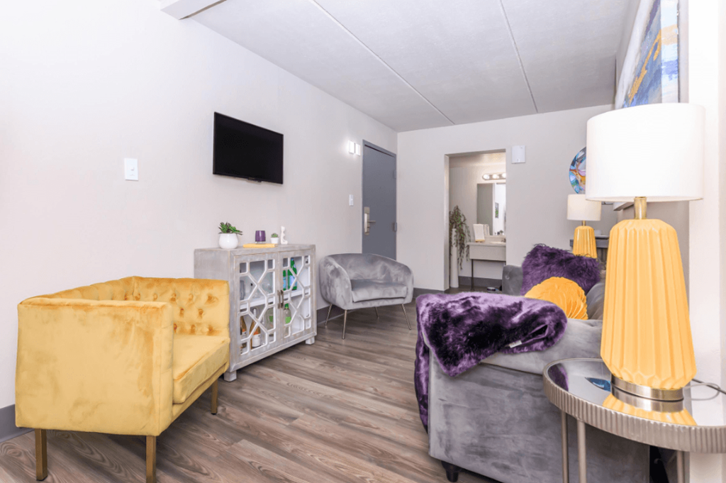 A living room with a yellow sofa and a grey couch.