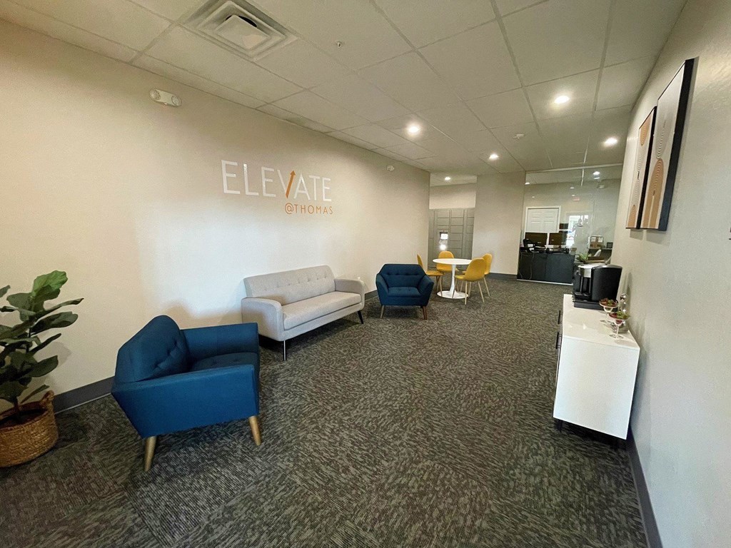 A room with a white wall that says ELEVATE on it.