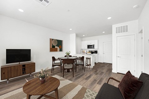 A modern living room with a wooden coffee table and a flat screen TV.