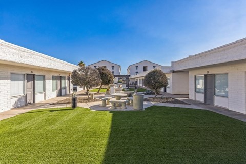 A modern building with a green lawn in front.