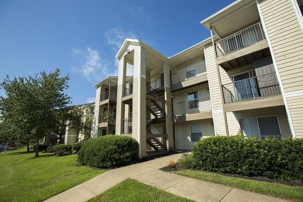 Apartment building with a green lawn in front.