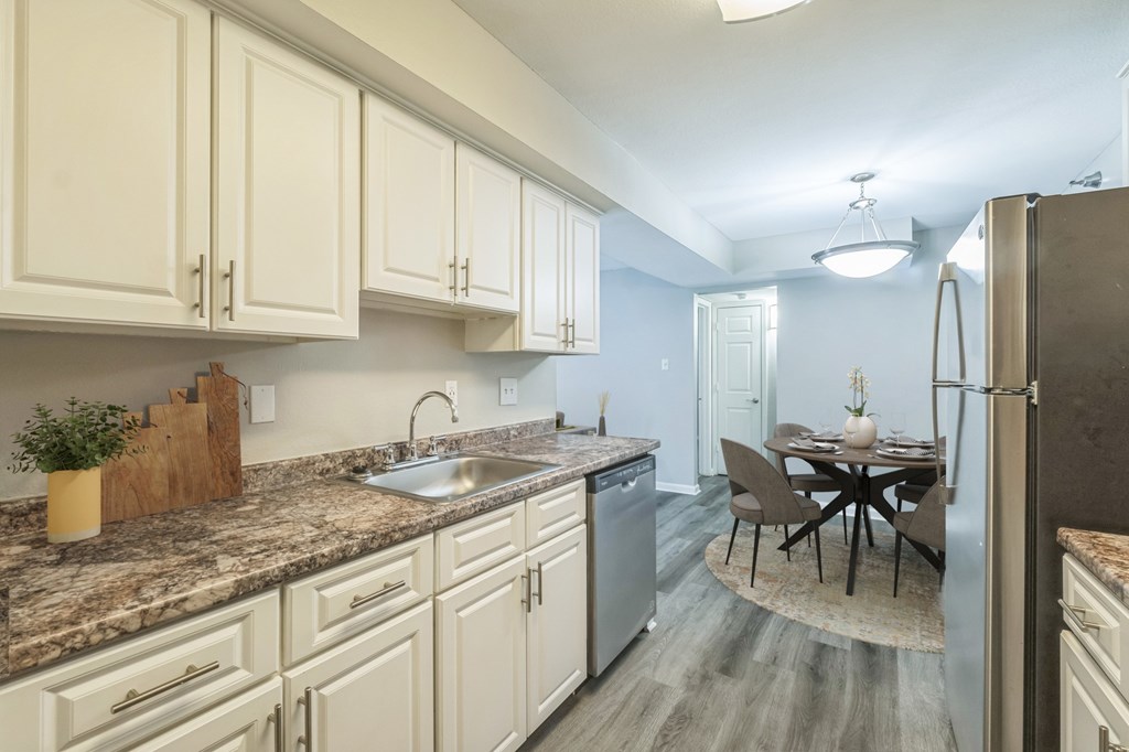 A kitchen with a table and chairs in the middle of the room.