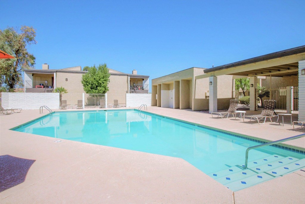 A swimming pool in front of a house.