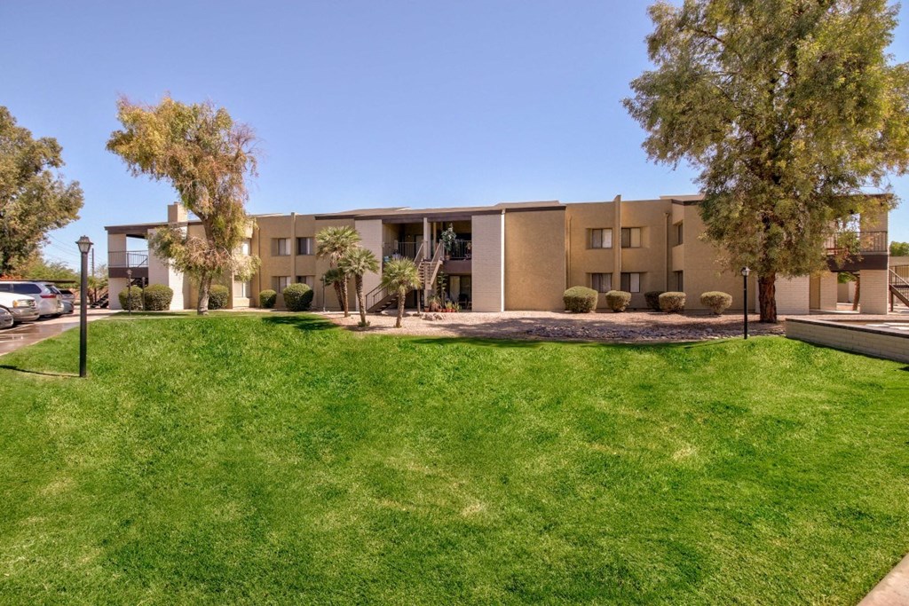 A large grassy area in front of a building.