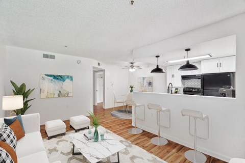 A modern living room with a white couch and a coffee table.