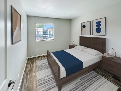 A bedroom with a bed, nightstand, and two framed pictures on the wall.