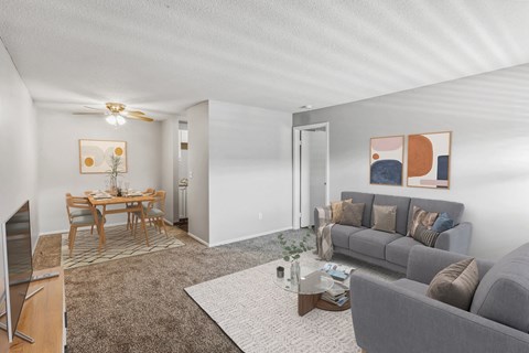 A living room with a grey couch and a coffee table.
