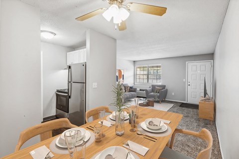 A dining room with a wooden table set for a meal.
