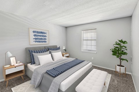 A bedroom with a bed, nightstand, and a plant.