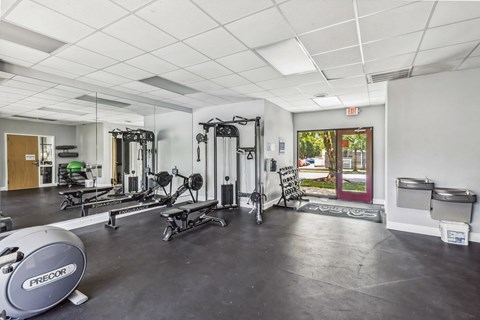 A gym with a variety of equipment including a Precor machine.