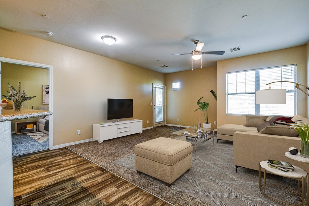 A living room with a flat screen TV and a couch.