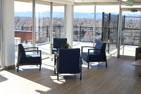 A room with a view of the cityscape through the windows.