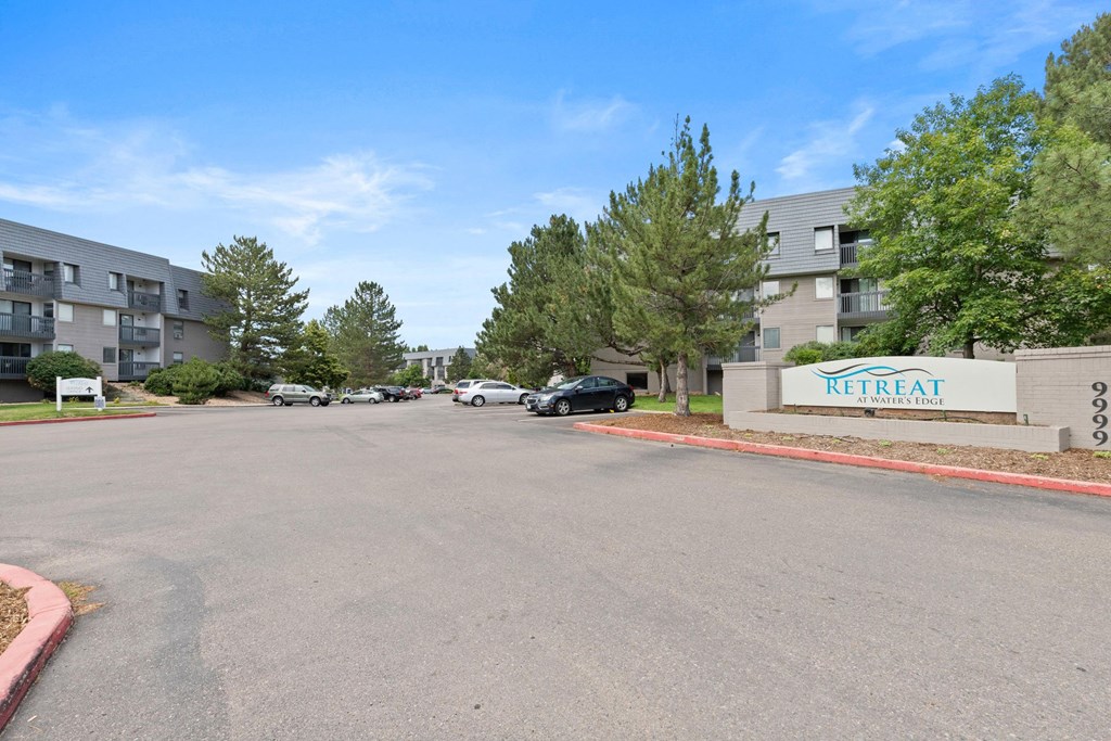 A parking lot in front of a Retreat Community Living building.