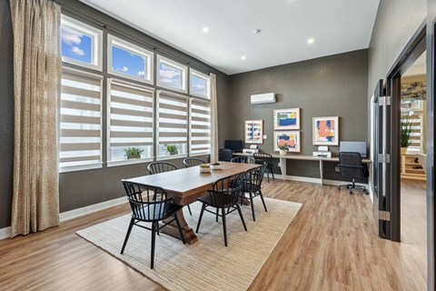 A modern dining room with a large table and chairs.