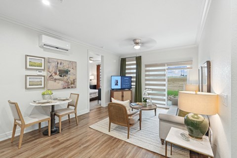 A living room with a dining table and chairs.
