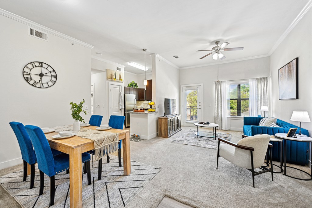 A dining room with a table and chairs.