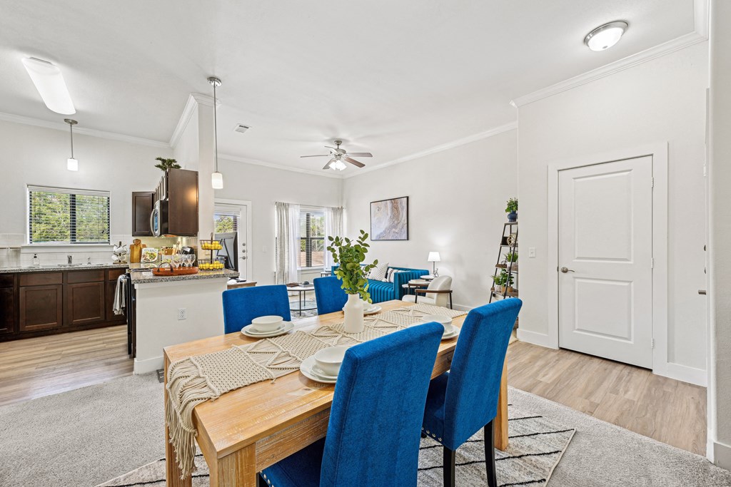 A dining room with a table set for four.