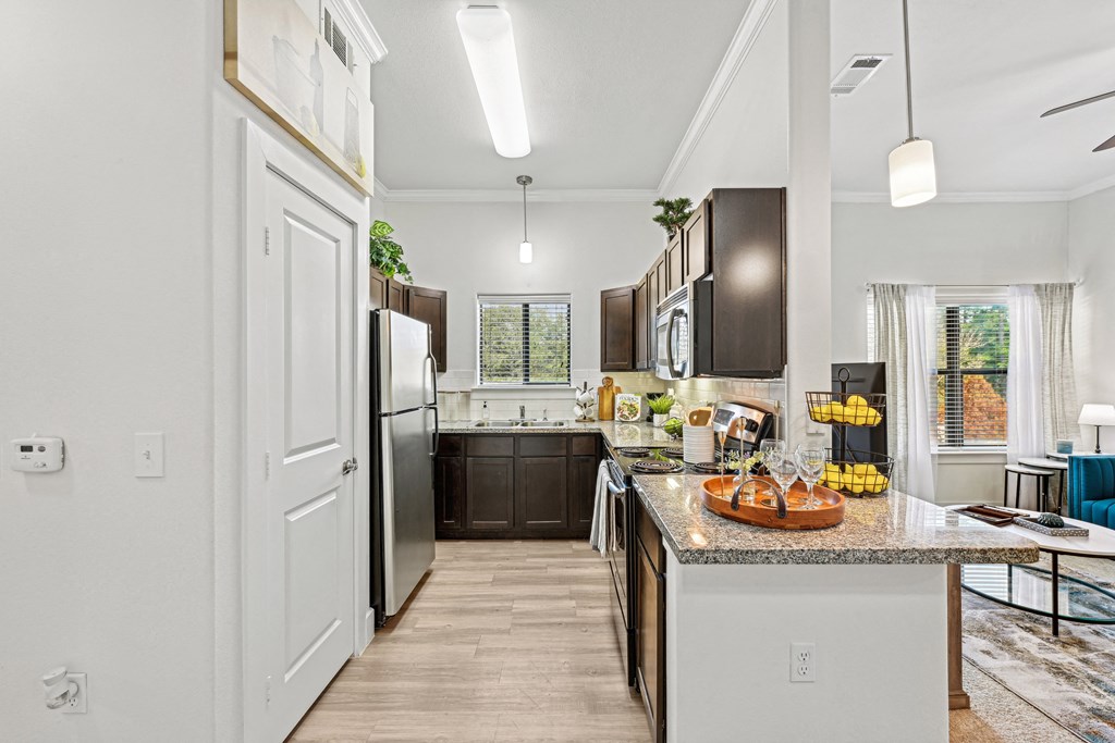 A kitchen with a granite countertop and a refrigerator.