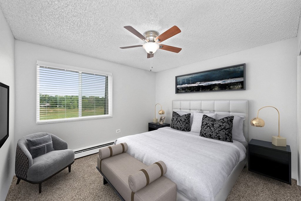 a bedroom with a bed and a ceiling fan