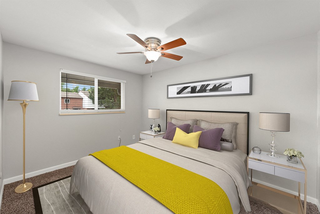 a bedroom with a large bed and a ceiling fan