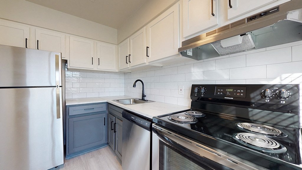 a kitchen with stainless steel appliances and white cabinets