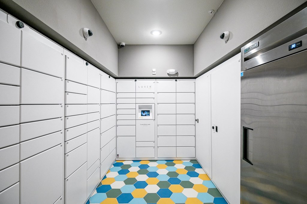 a large white locker room with a colorful tile floor