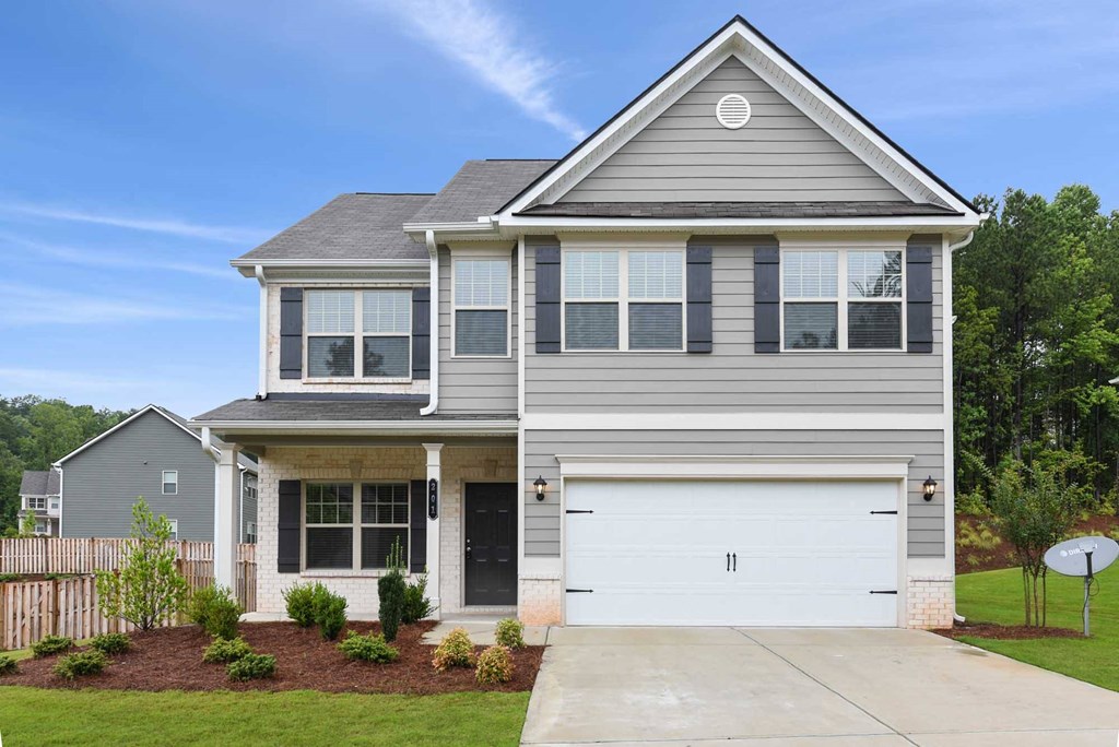a gray house with a white garage door