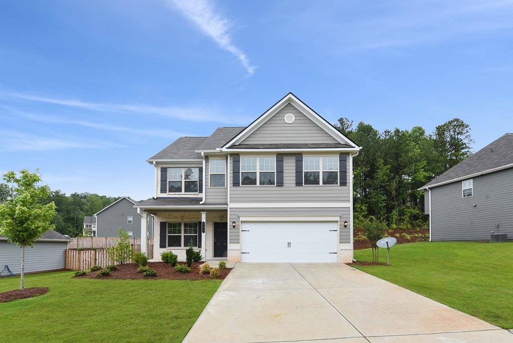 a gray house with a white garage door