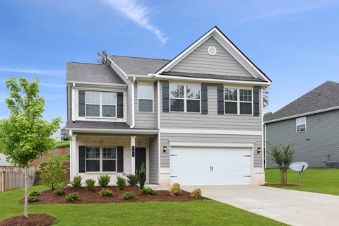 a gray house with a white garage door