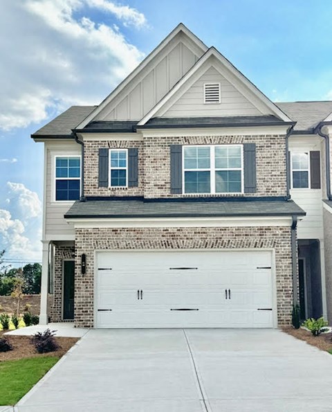 a white house with a white garage door