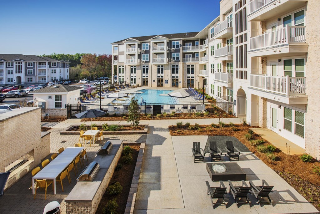 a rendering of an apartment building with a swimming pool