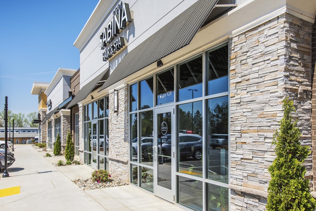 the facade of a building with glass doors and a sign that reads