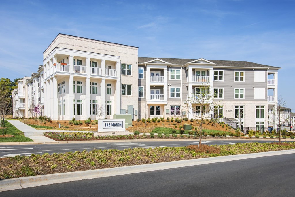 a large apartment building with a street in front of it