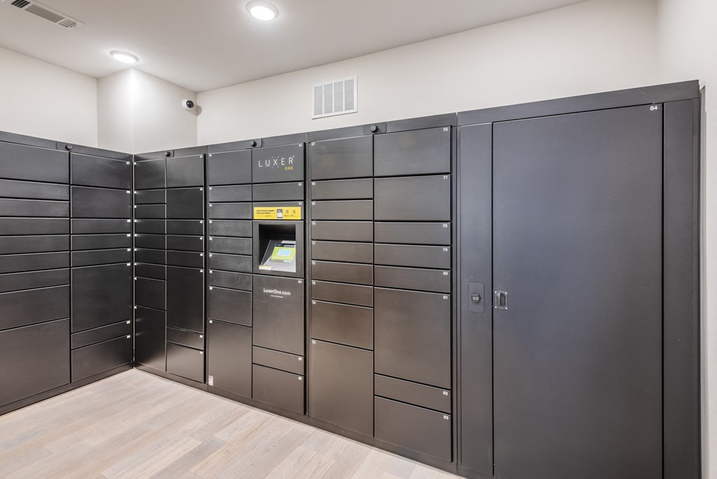 a large set of lockers in a room with a wooden floor