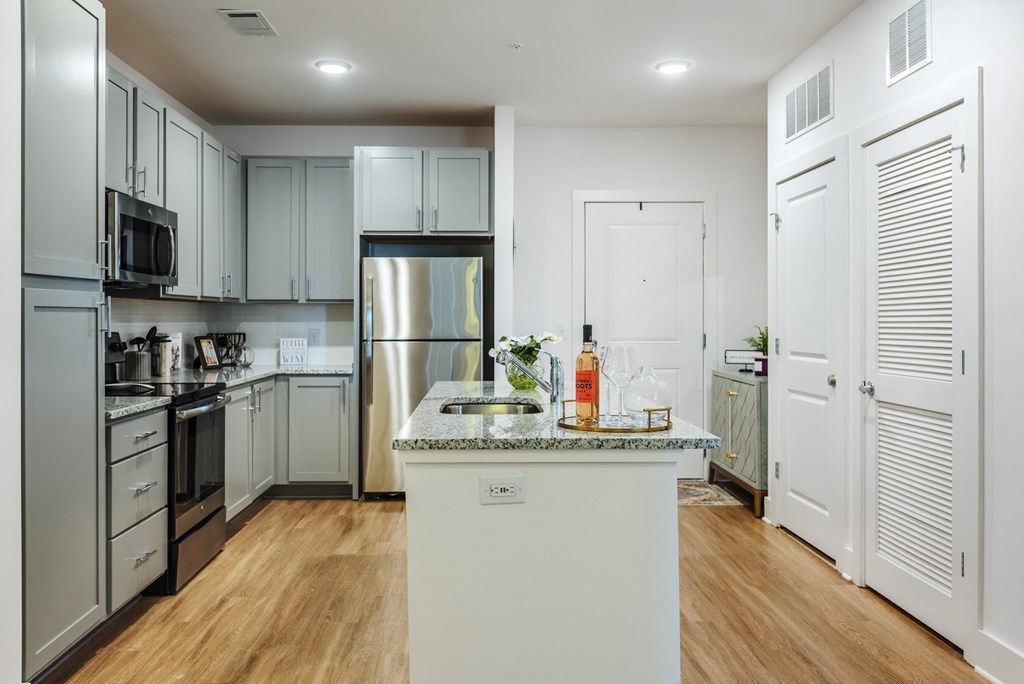 a kitchen with stainless steel appliances and white cabinets