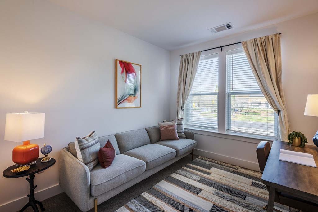 a living room with a couch and a large window