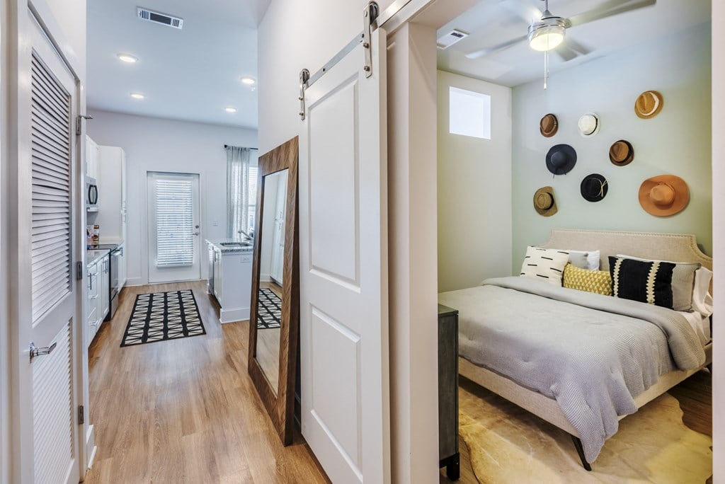 a bedroom with a bed and a bathroom with a sink