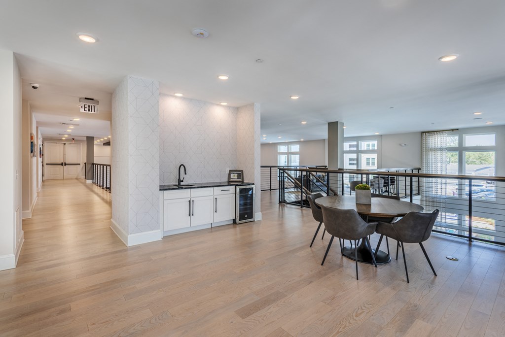 a large living room with a kitchen and a dining table
