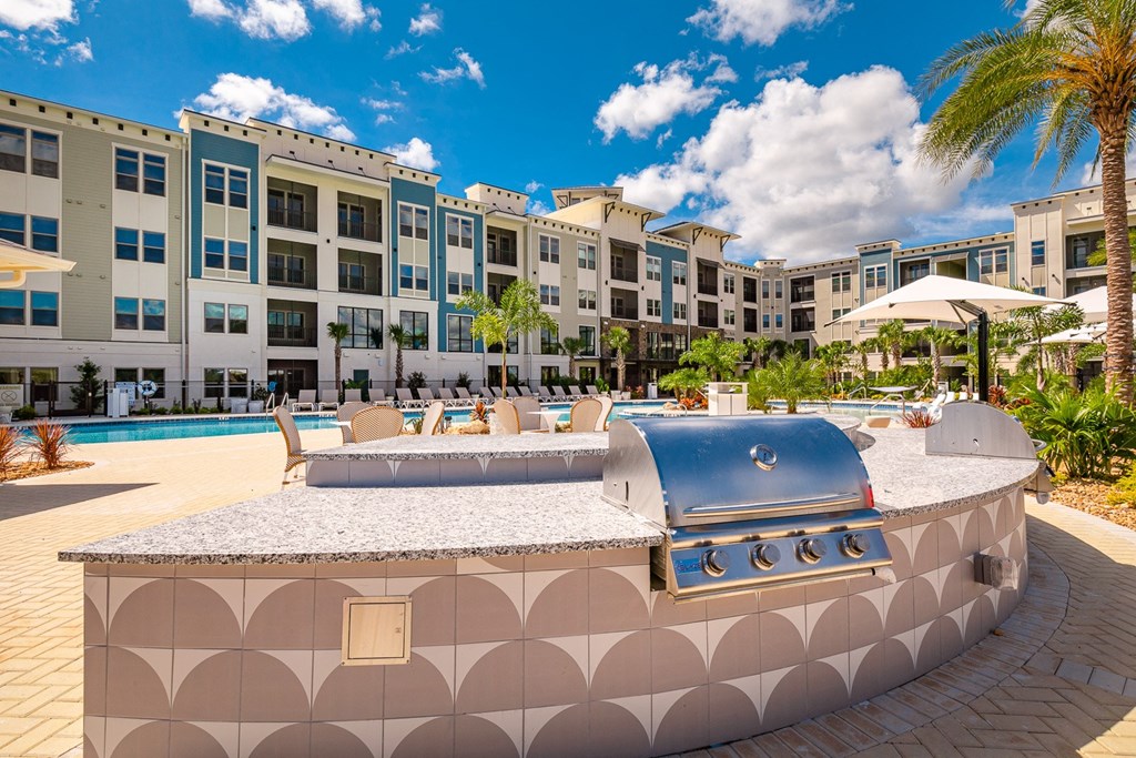 a pool with a bar and a grill in front of an apartment building