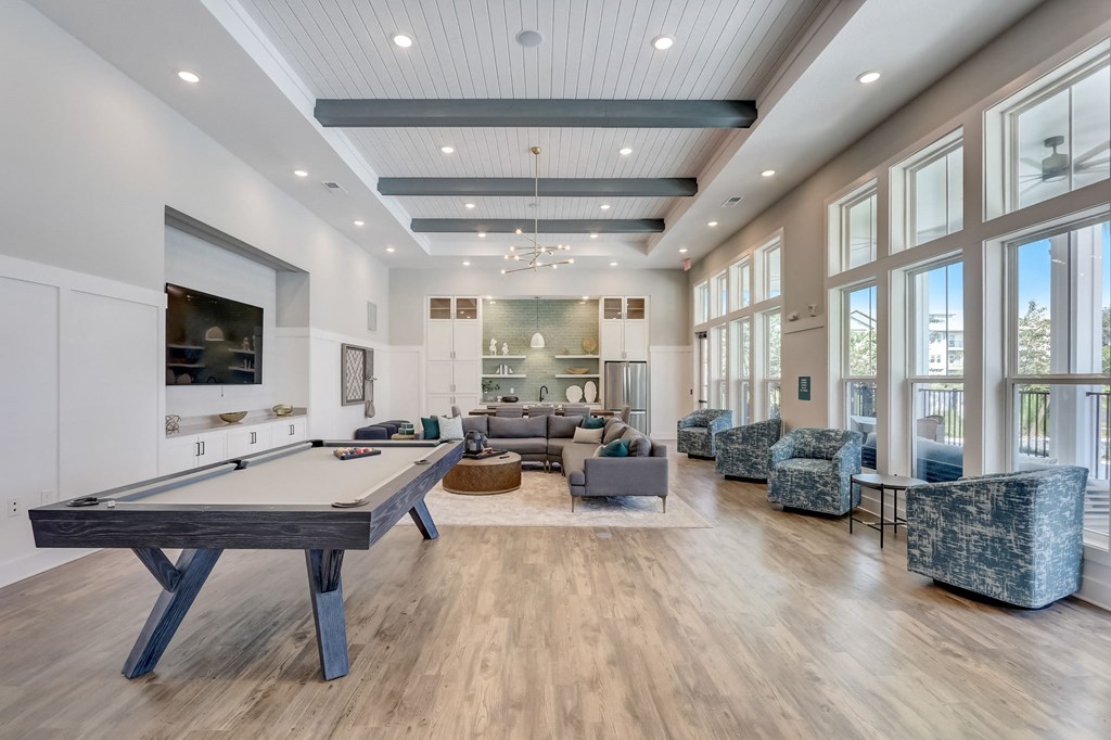 a game room with a pool table and a tv
