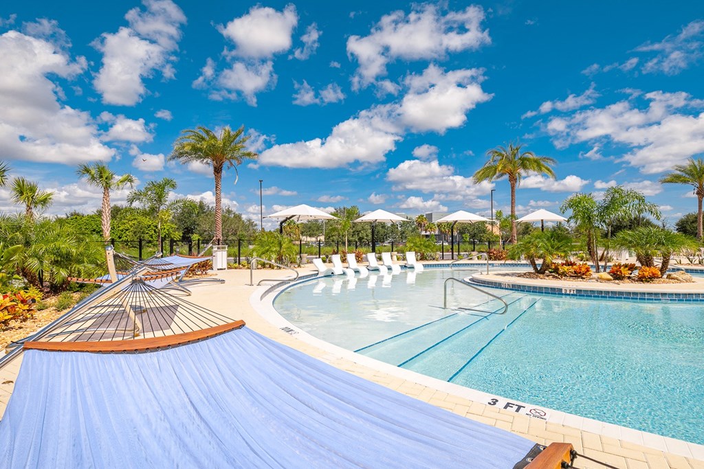 a swimming pool at a resort with palm trees