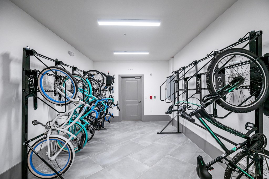 a row of bikes hanging on a wall in a white room