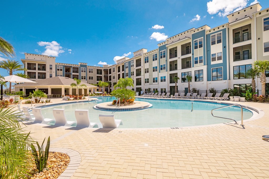 a large swimming pool in front of an apartment building