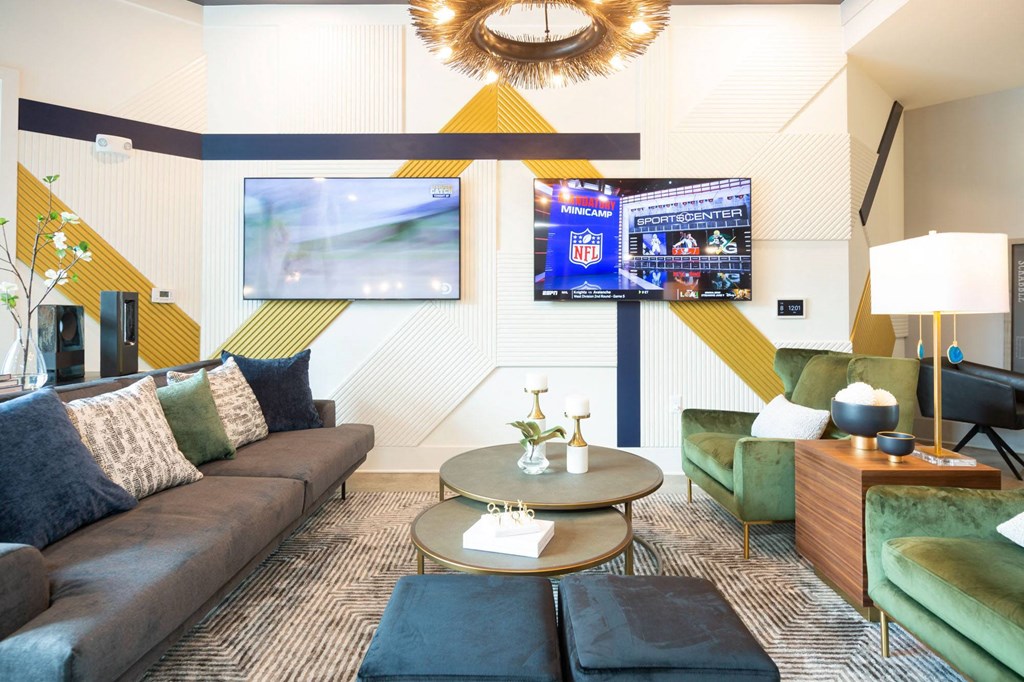 a living room with couches and chairs and a tv