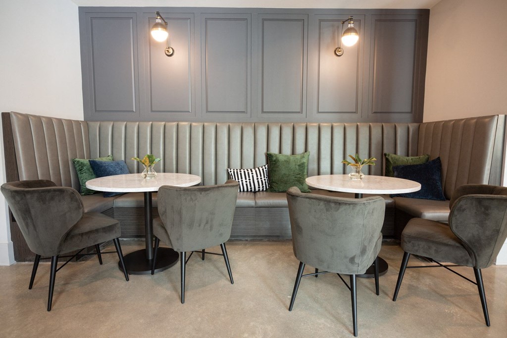 a dining room with two tables and chairs and a couch