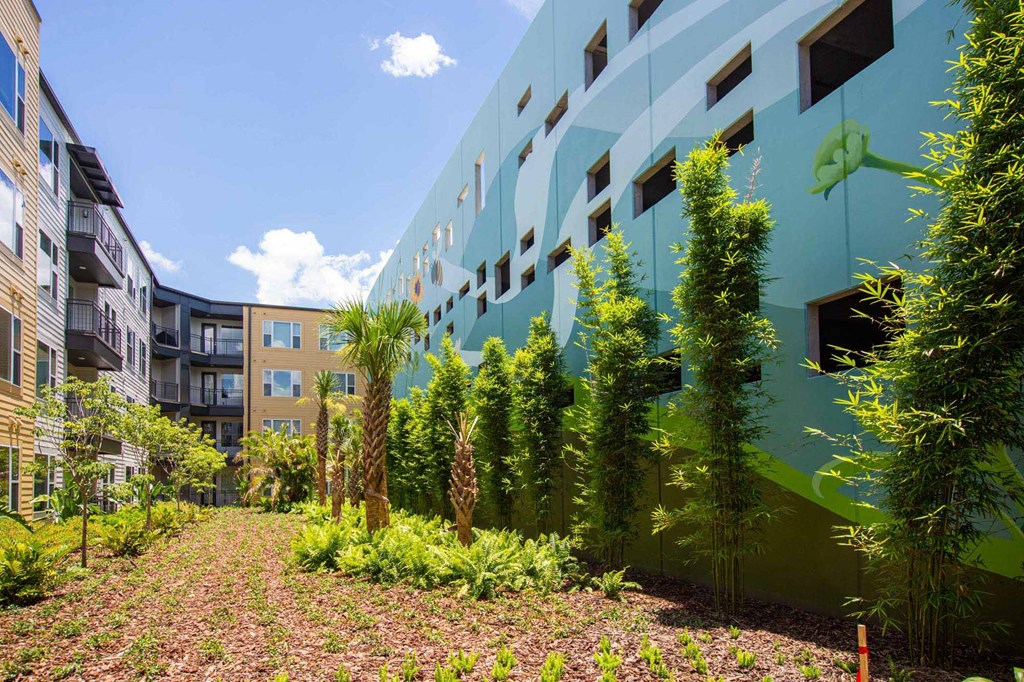 a courtyard with trees and plants in front of a building